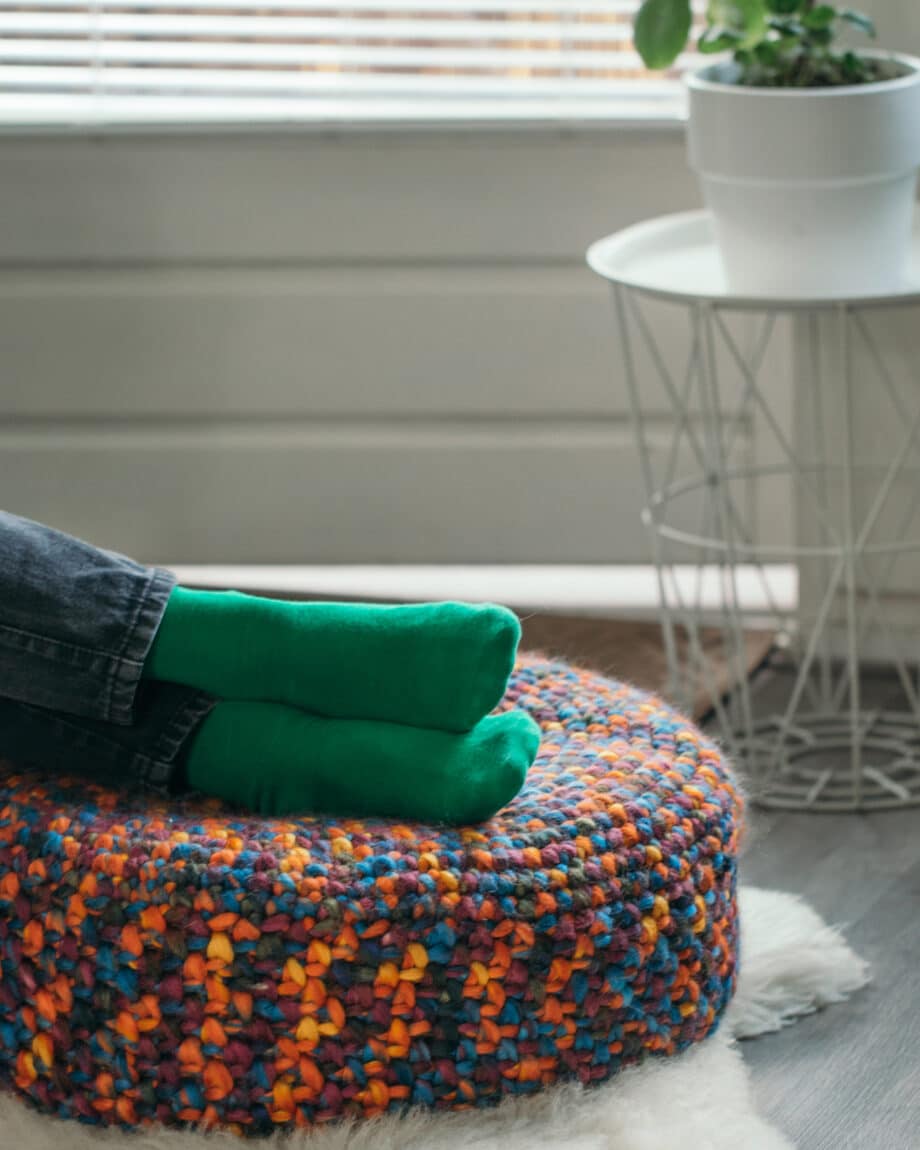 knitted rainbow pouf with feet on it, rainbow pouf in interiors