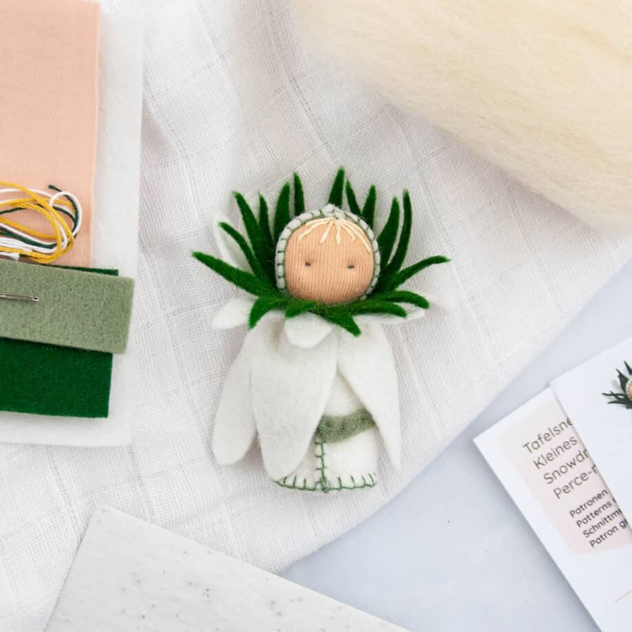 Flatlay snowdrop table doll