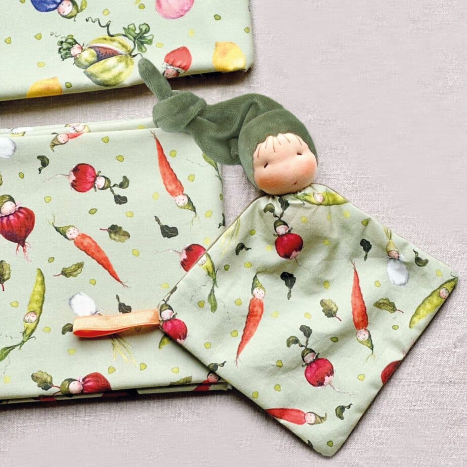 Dollbelge DIY kit folded blanket doll - folded blanket doll making kit. Close-up of 100% cotton Fruit fabric with vibrant fruit illustrations by Daniela Drescher.